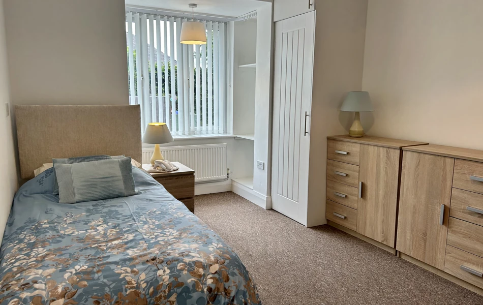 A spacious bedroom with ample storage for personal belongings