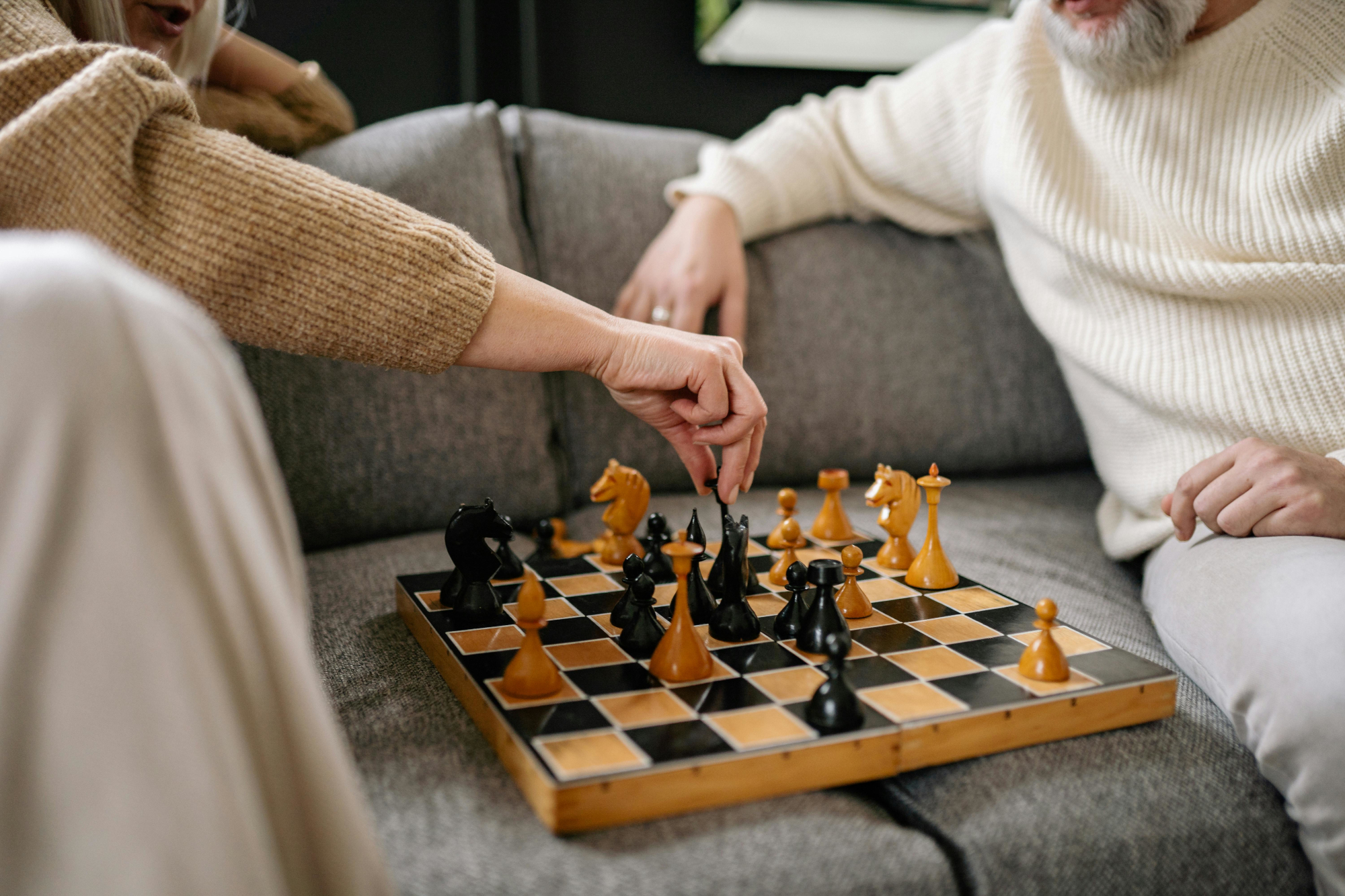 Two Older People Playing Chess Together