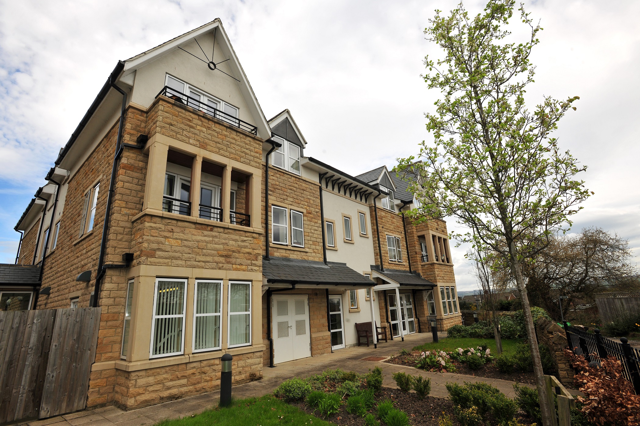 Abbeyfield The Beeches is modern stone house with balconies