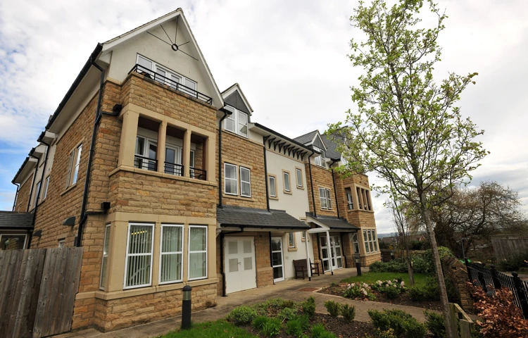 Abbeyfield The Beeches is modern stone house with balconies