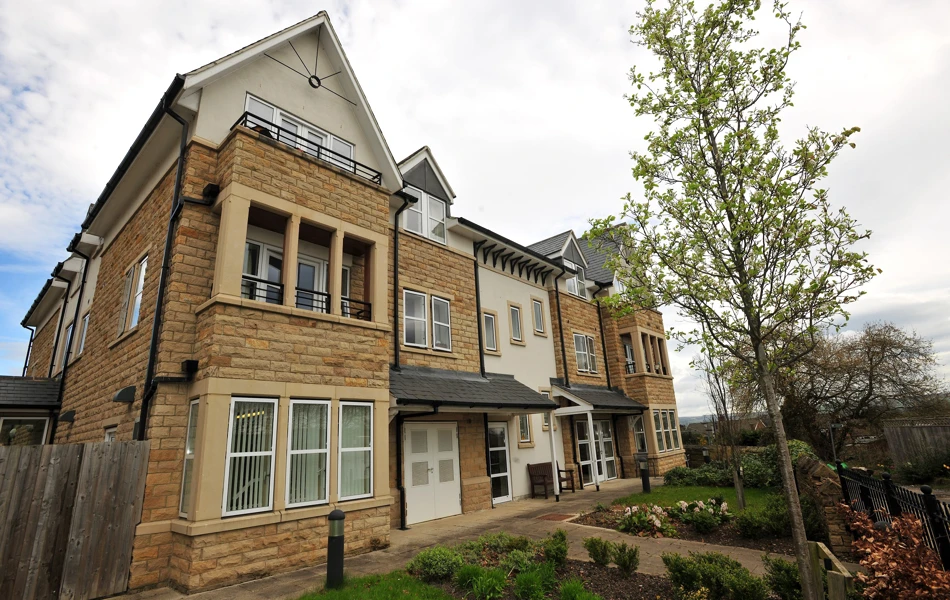 Abbeyfield The Beeches is modern stone house with balconies