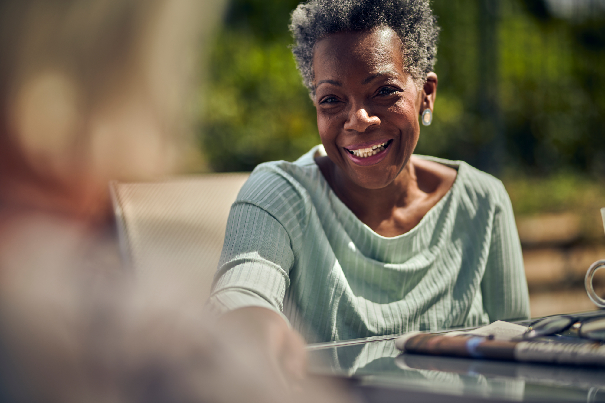 Smiling Older Woman Sitting In The Sunshine