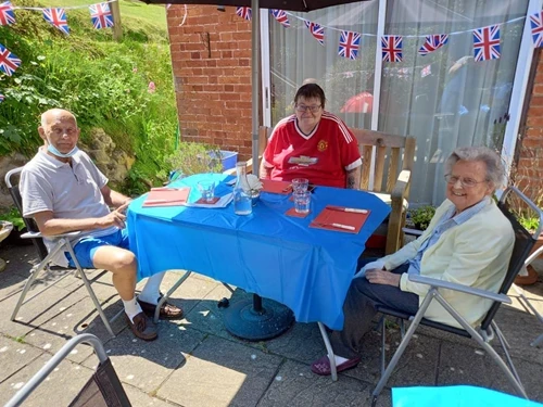Residents sat at a table on the patio