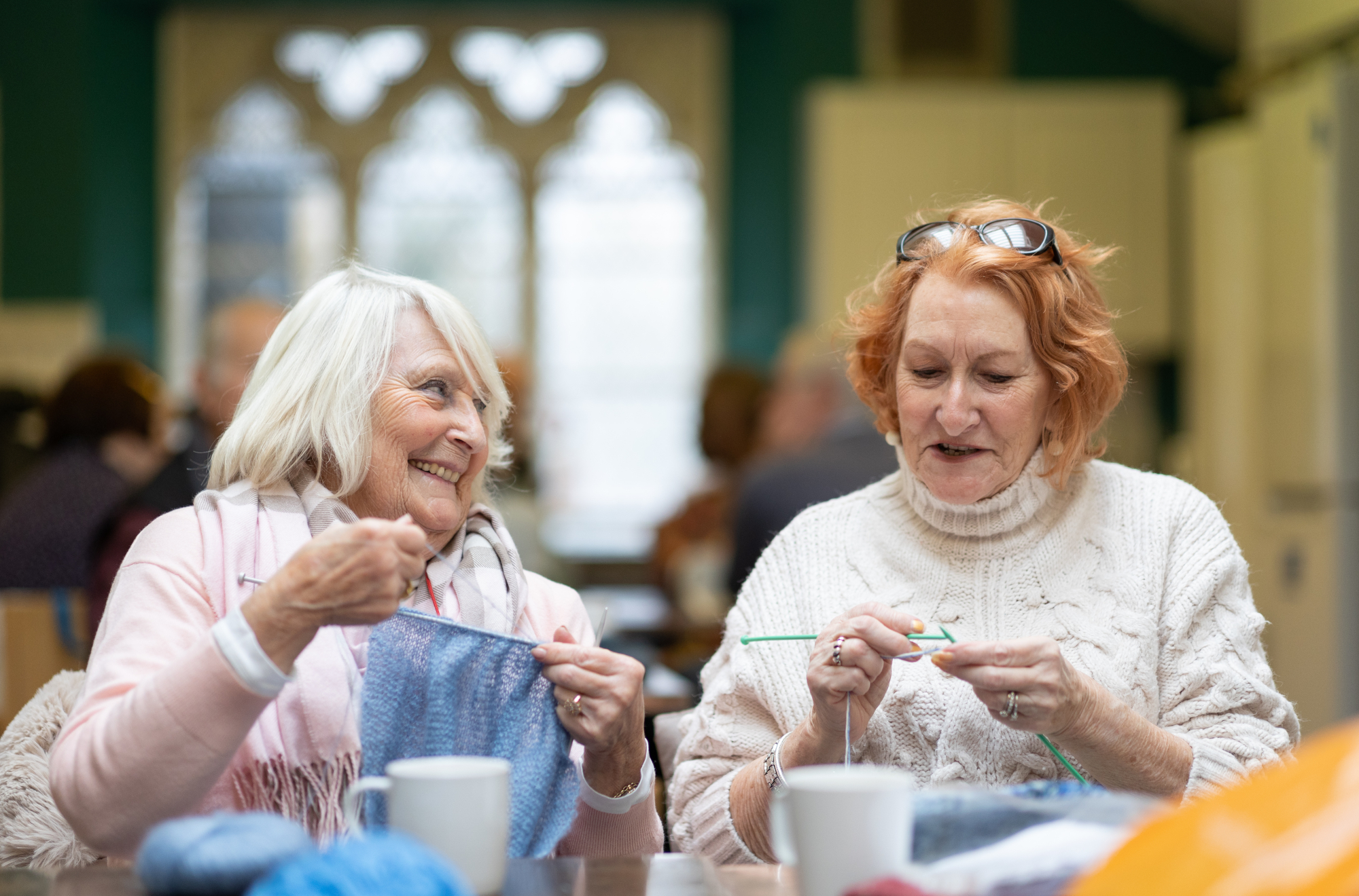 Two Happy Older Women Knitting Together