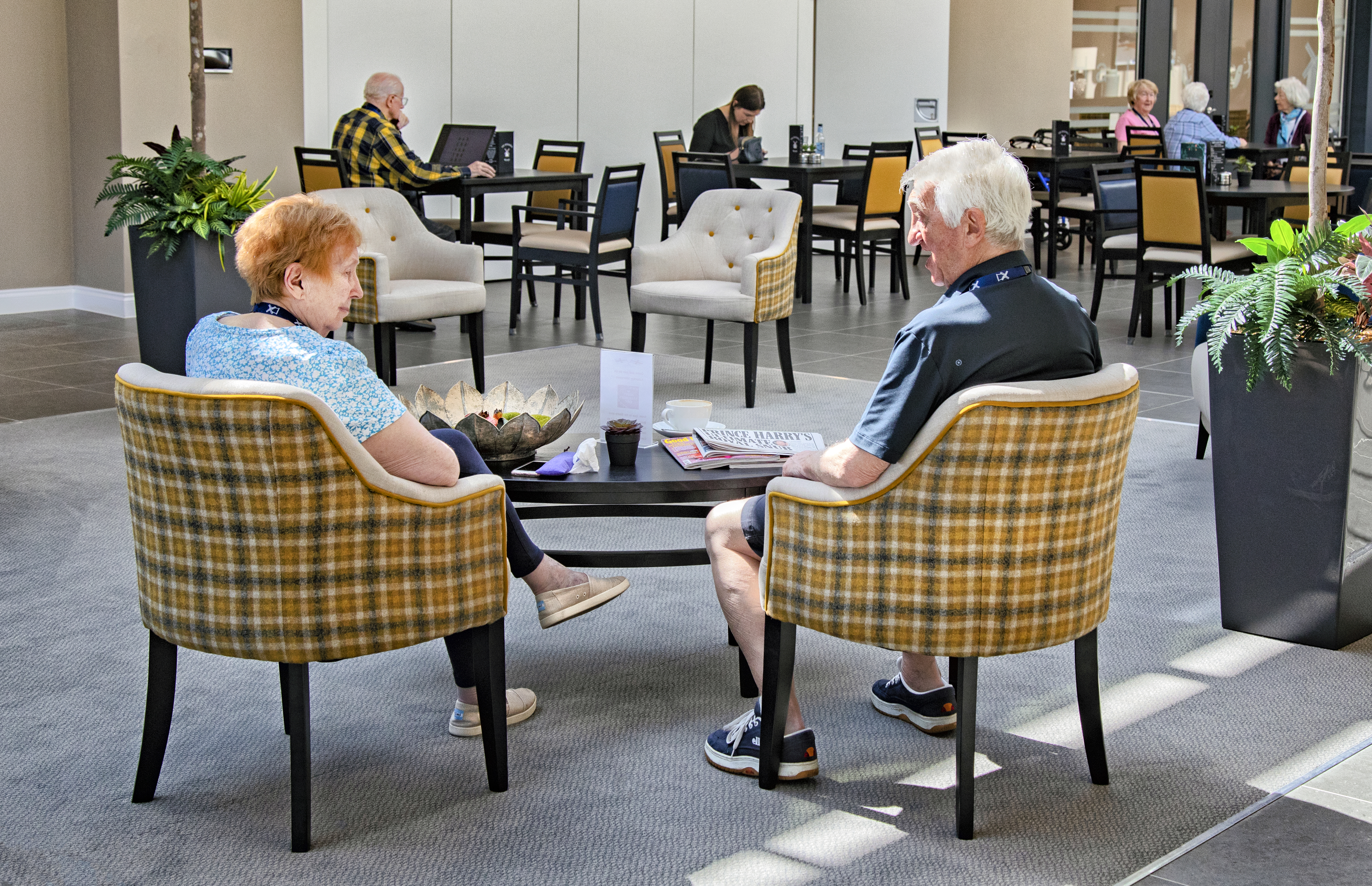Residents relaxing in communal area of Polly's Field Village, Braintree CM7 5XD