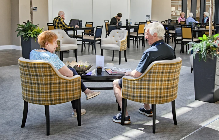 Residents relaxing in communal area of Polly's Field Village, Braintree CM7 5XD