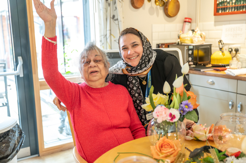 Resident Enjoying Some Flower Arranging With Staff Member