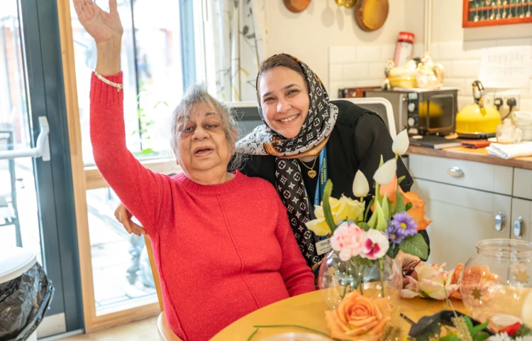 Resident Enjoying Some Flower Arranging With Staff Member
