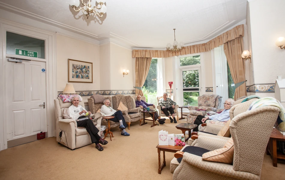 The bright spacious lounge with residents sat together