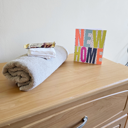 Side Cabinet With Towel Chocolate And New Home Card At Downing House, M20 4PP