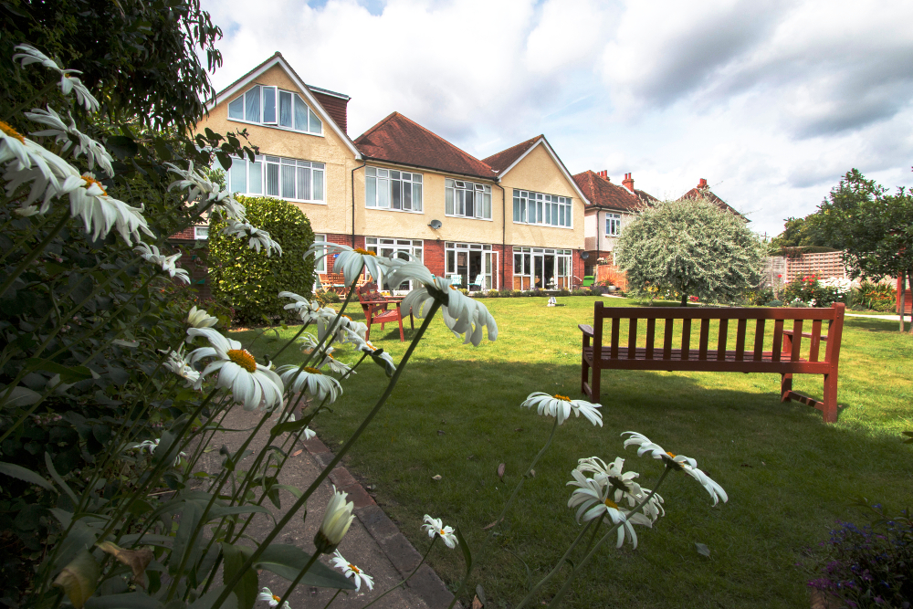 Large garden at Oakshade with benches so that residents can while away the hours in the sunshine