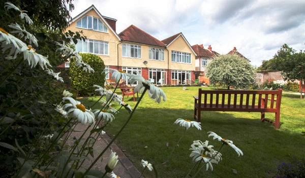 Large garden at Oakshade with benches so that residents can while away the hours in the sunshine