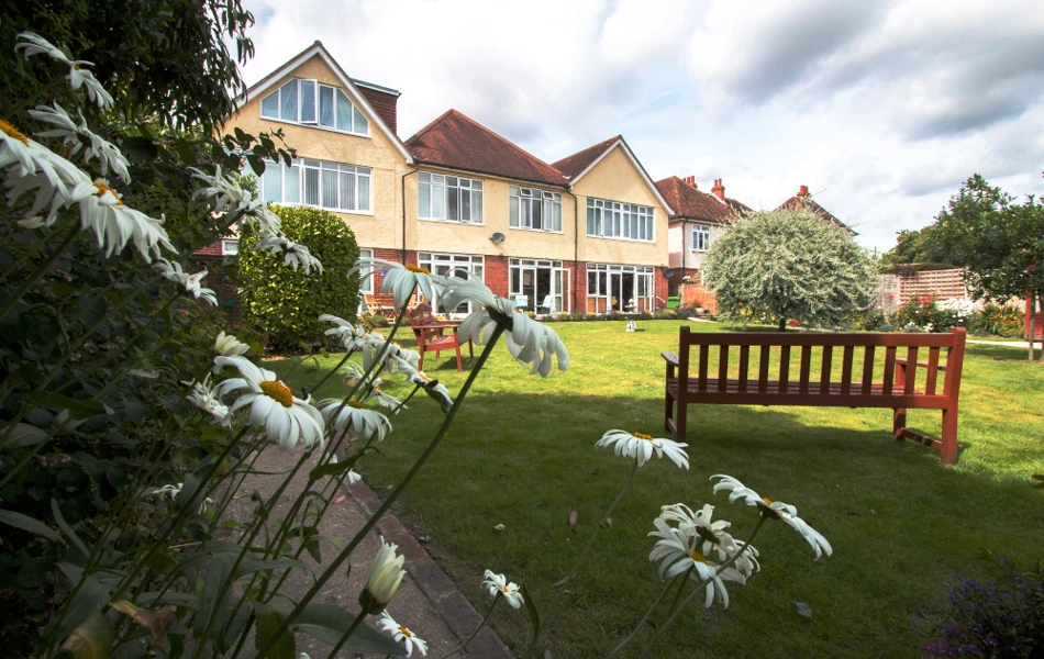 Large garden at Oakshade with benches so that residents can while away the hours in the sunshine