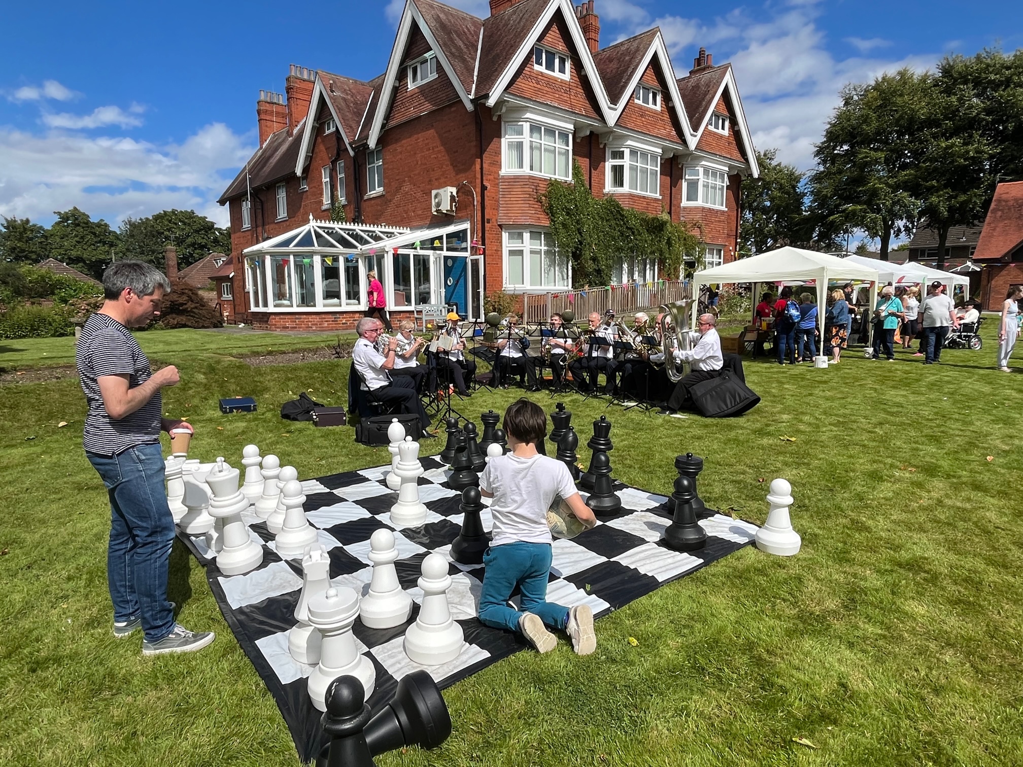 Chess, brass band and residents out on the lawn at Sir Charles Starmer House, Darlington DL3 8PD