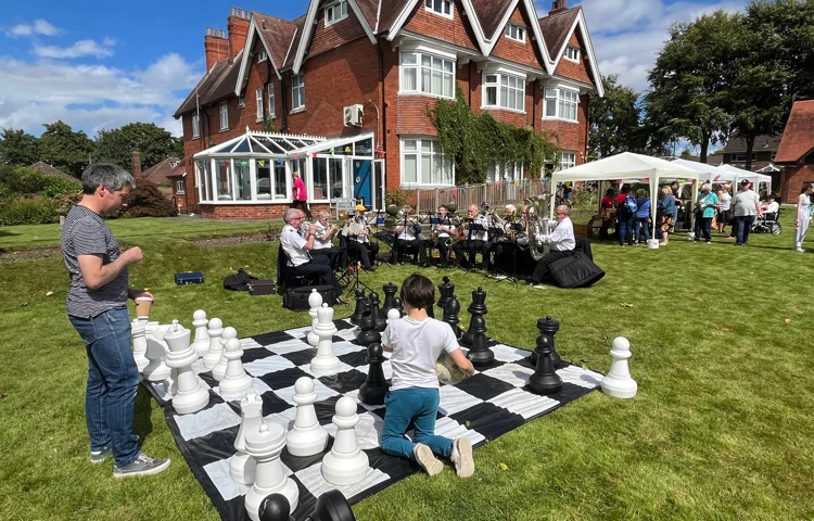 Chess, brass band and residents out on the lawn at Sir Charles Starmer House, Darlington DL3 8PD