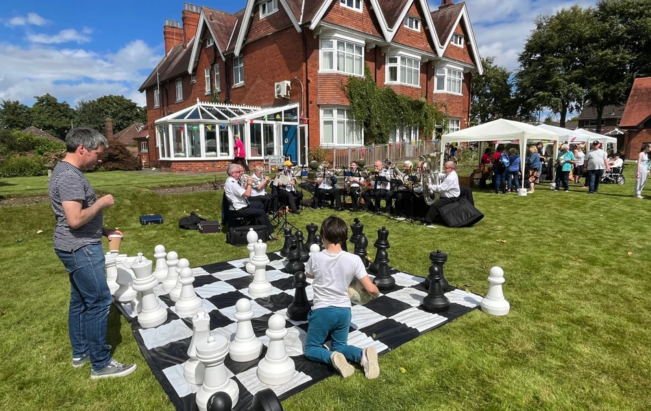 Chess, brass band and residents out on the lawn at Sir Charles Starmer House, Darlington DL3 8PD