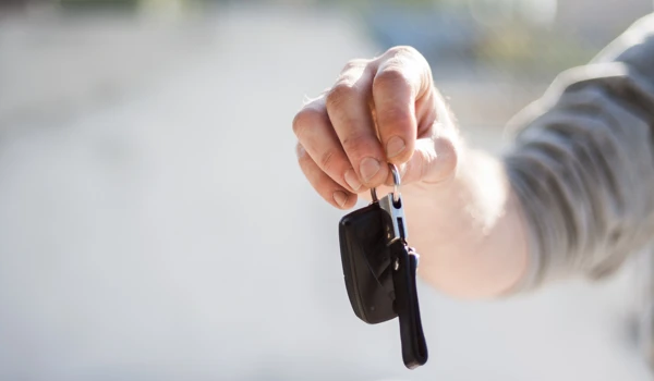 Man Holding Car Keys