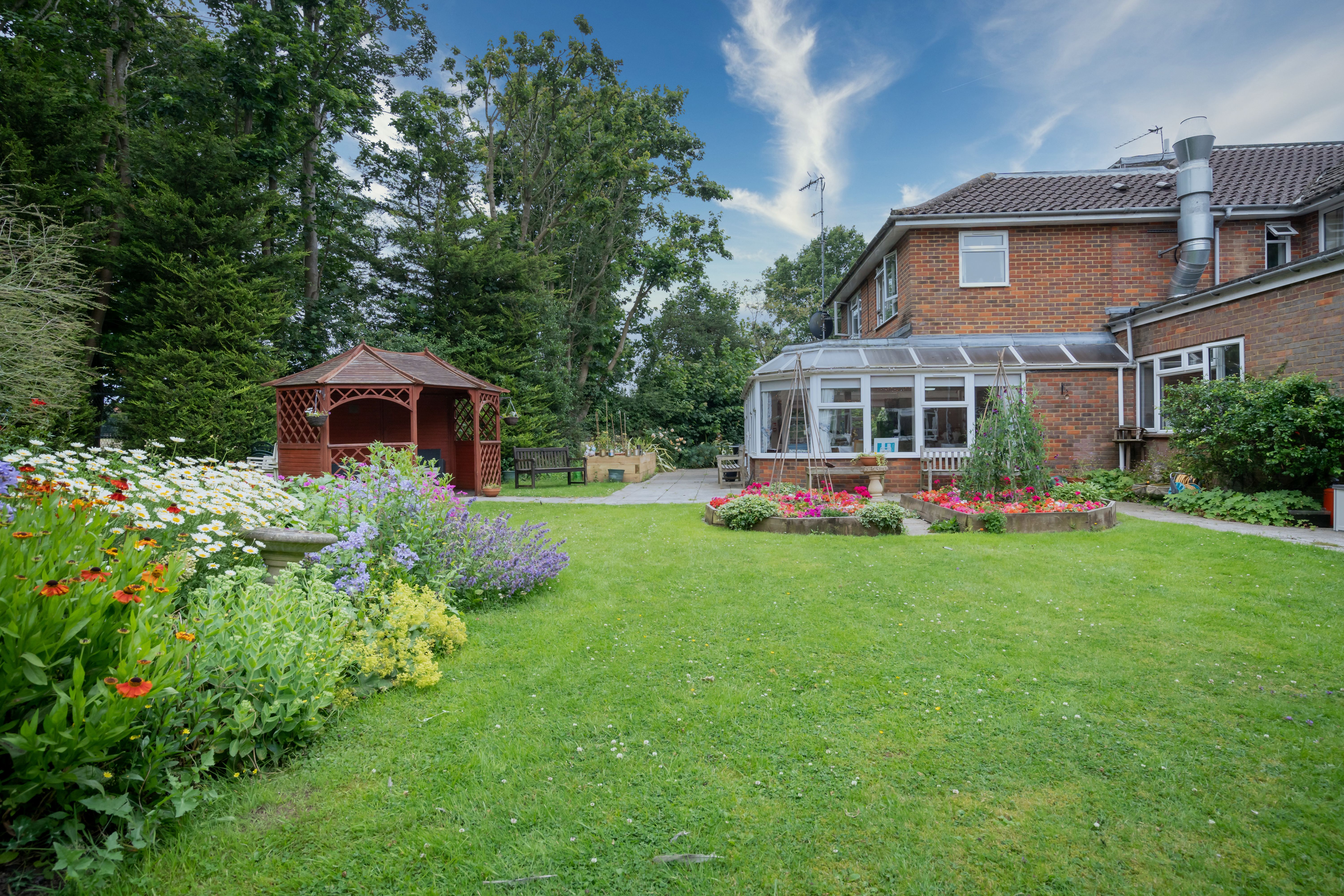 External view of Pratt House garden and pergola and flowers
