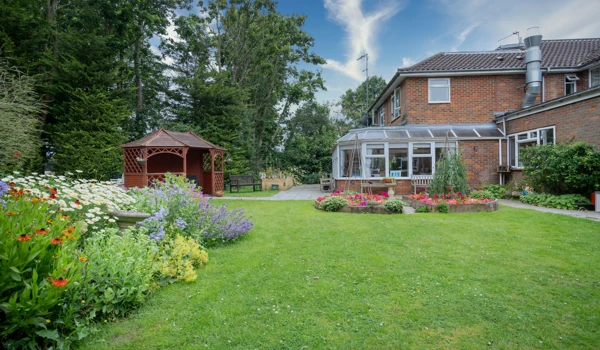External view of Pratt House garden and pergola and flowers