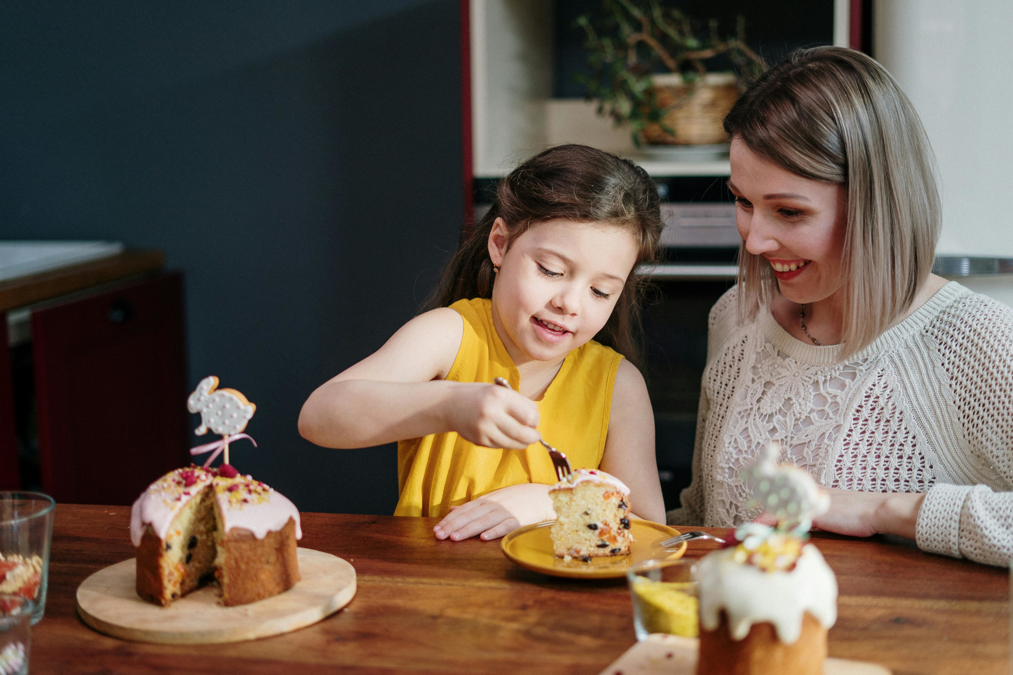 Mother And Daughter Enjoying A Slice Of Cake