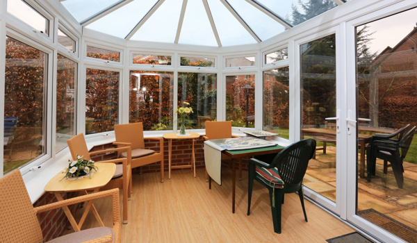 Sit back and relax in our conservatory with view of the garden at Bailey House