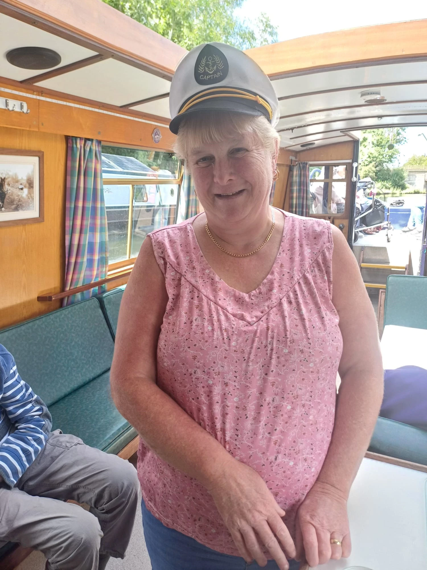 A woman in a captains hat on a barge