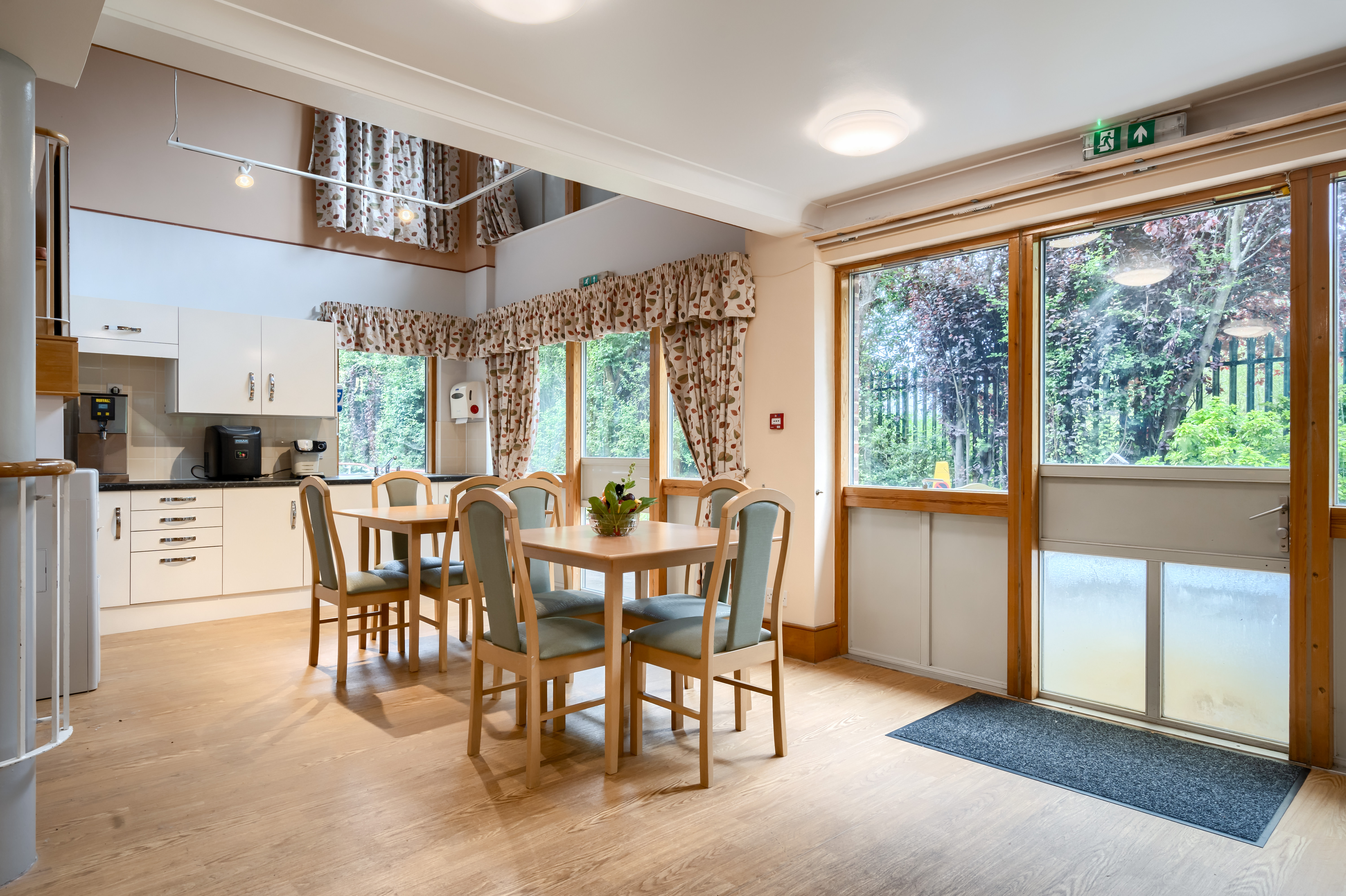 Cafeteria with table and chairs at Abbeyfield House, New Malden