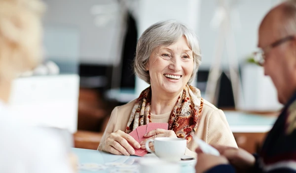 Residents Sitting Around A Table Playing Cards. Jpg