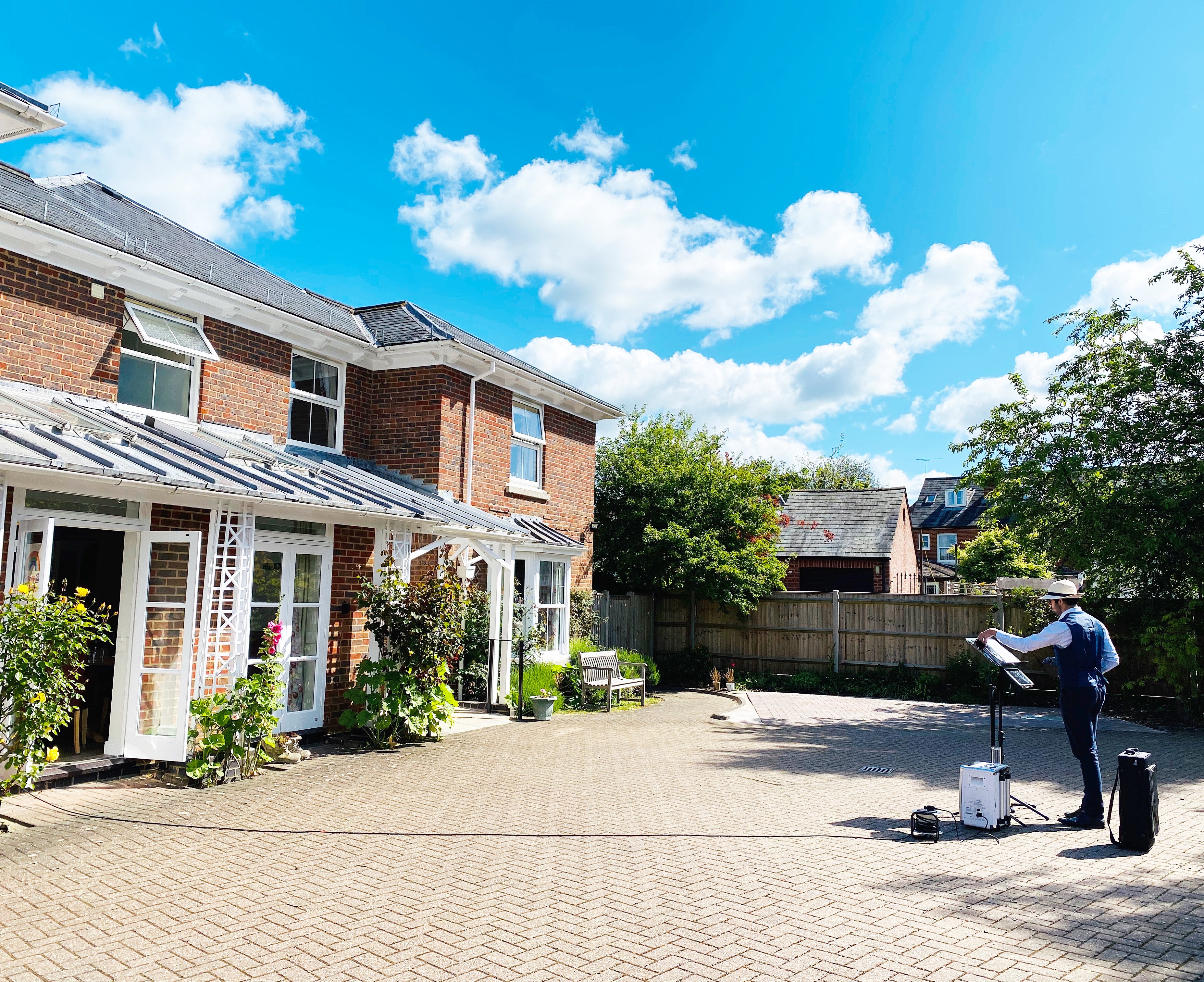 Saxophonist plays outside Abbeyfield House Romsey