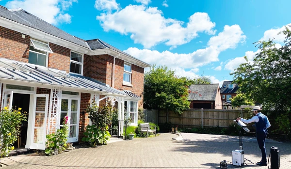 Saxophonist plays outside Abbeyfield House Romsey