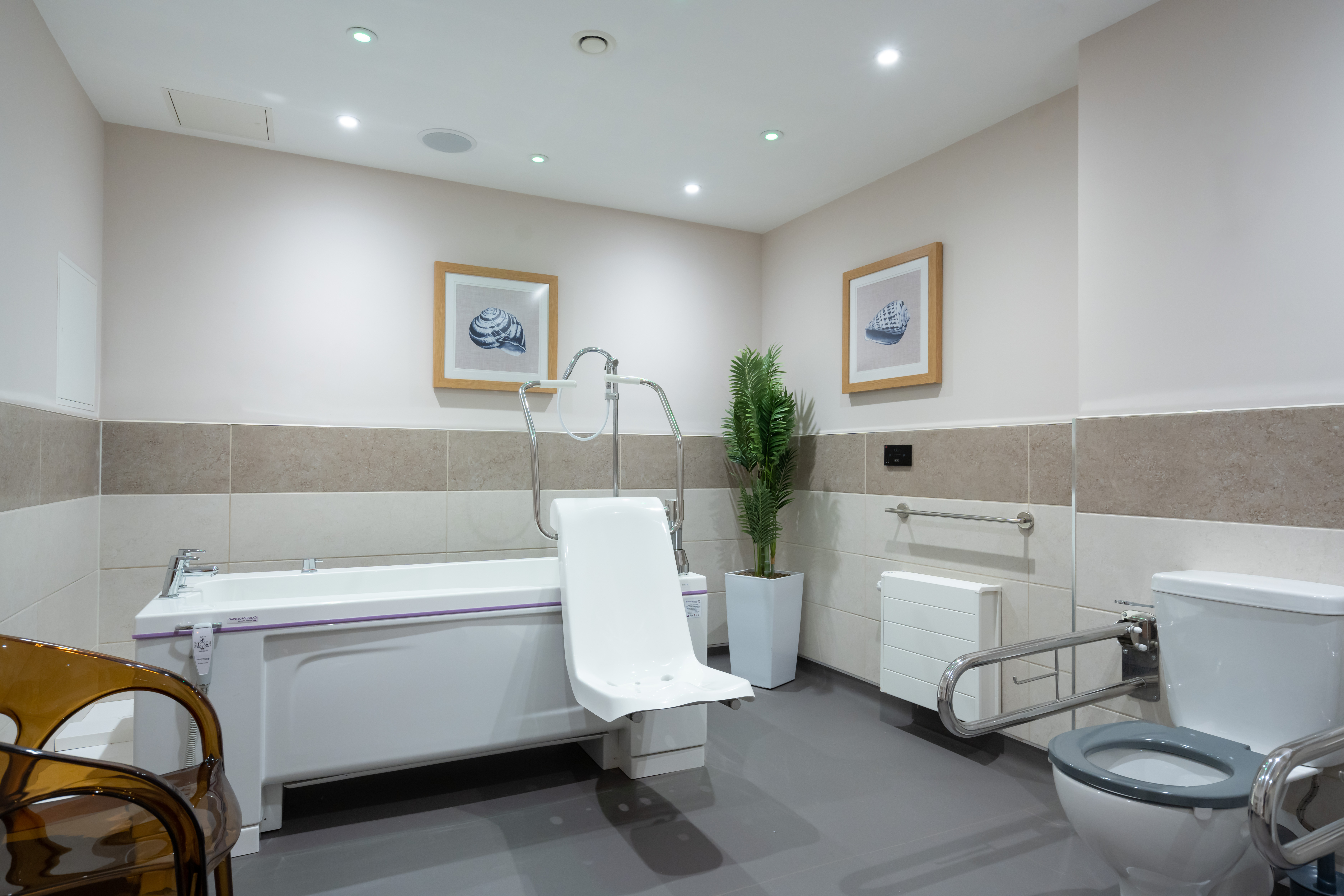 Accessible bathroom at Westall House in Horsted Keynes, featuring a specialised bathtub and support bars