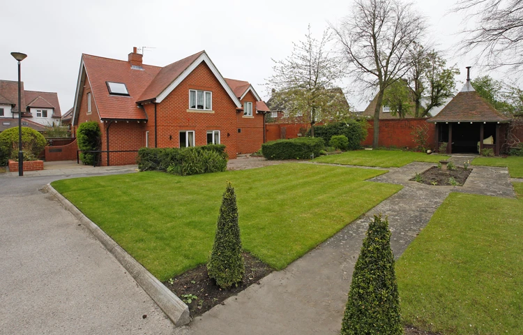 Well kept gardens with conifers and shrubs at Earl Keelan House DL3 8PD