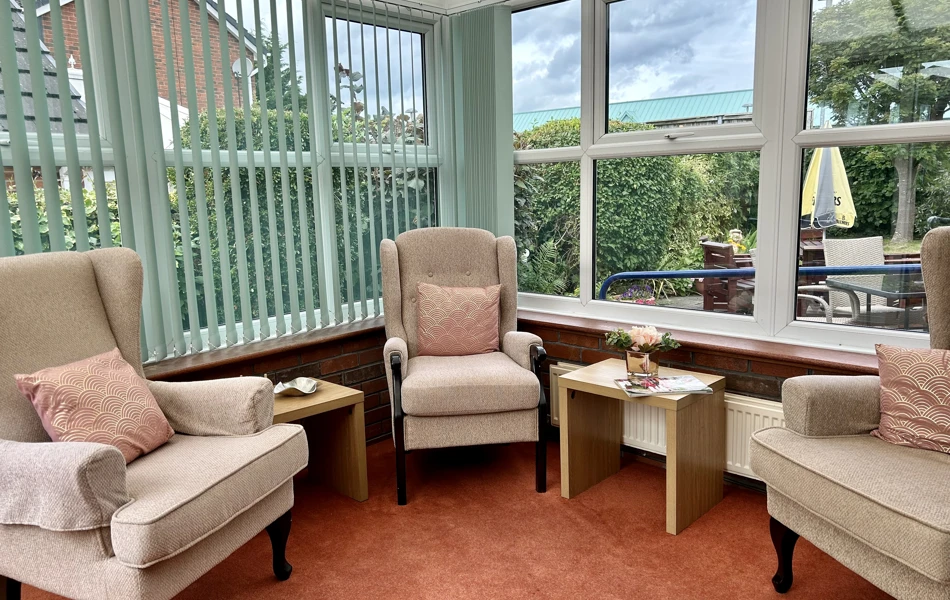 Our bright and airy conservatory with ample seating for residents
