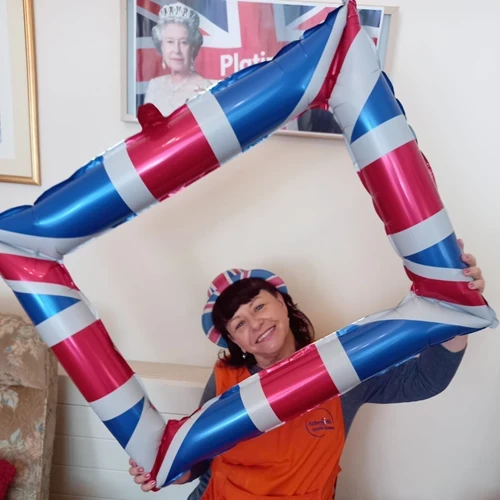 A lady posing in an inflatable union jack picture frame