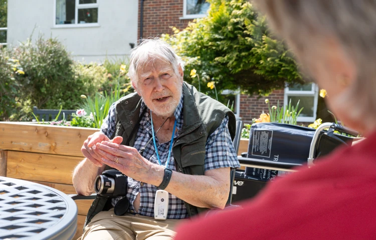 Resident Enjoying The Sunshine In The Garden At Nower House