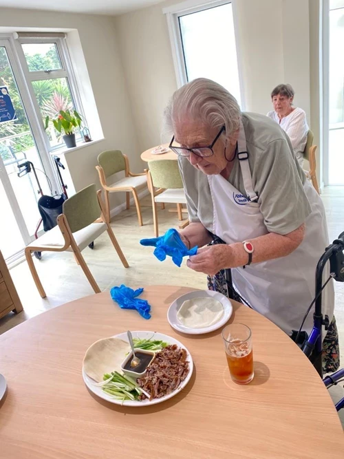 Resident enjoying duck pancakes