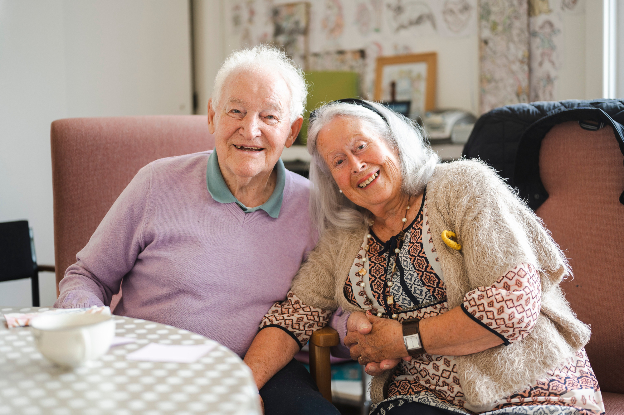 Older Couple Sitting Together With A Hot Drinks
