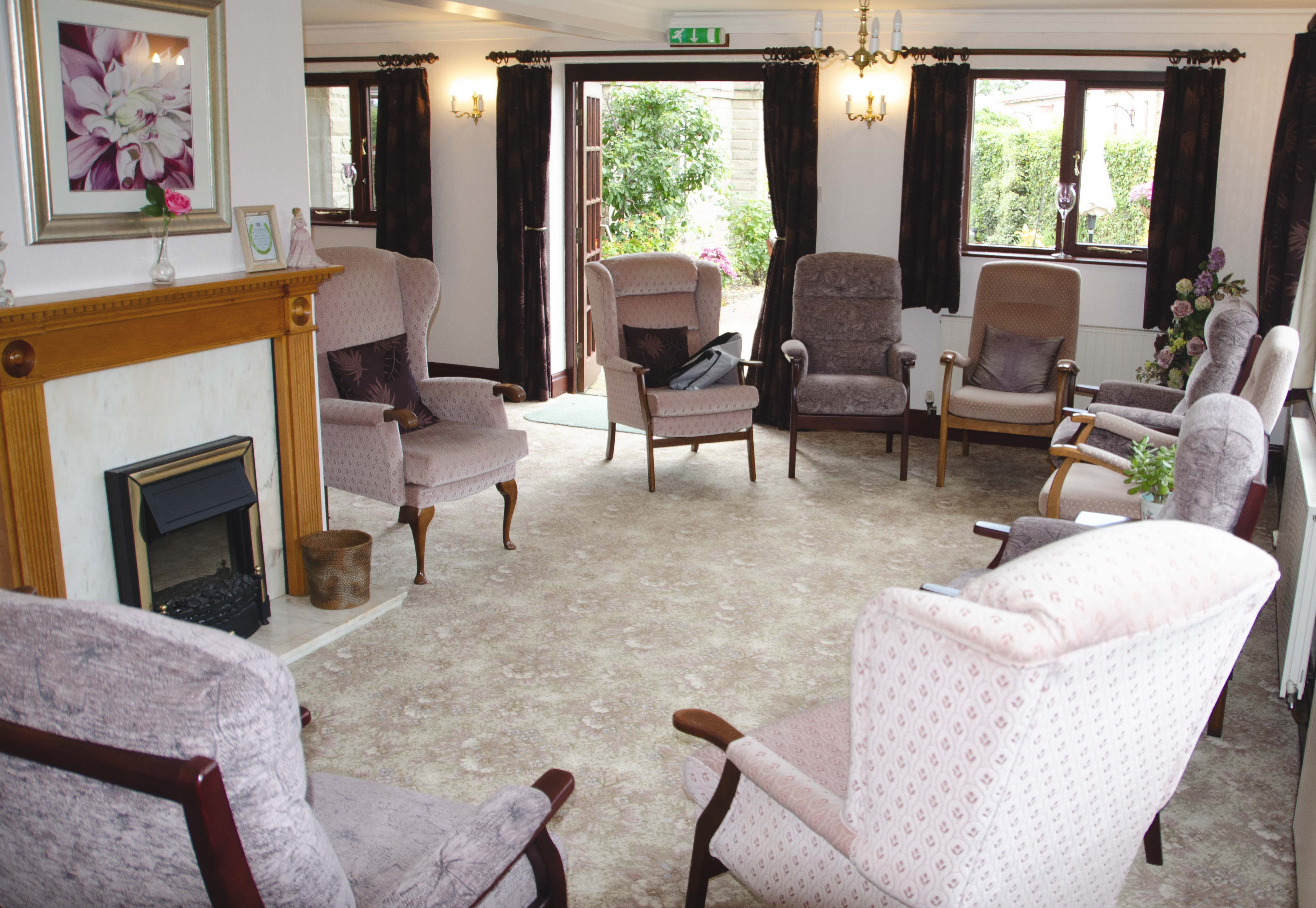 Lounge area with high-back chairs and fireplace at Castle View House, BB7 2DT