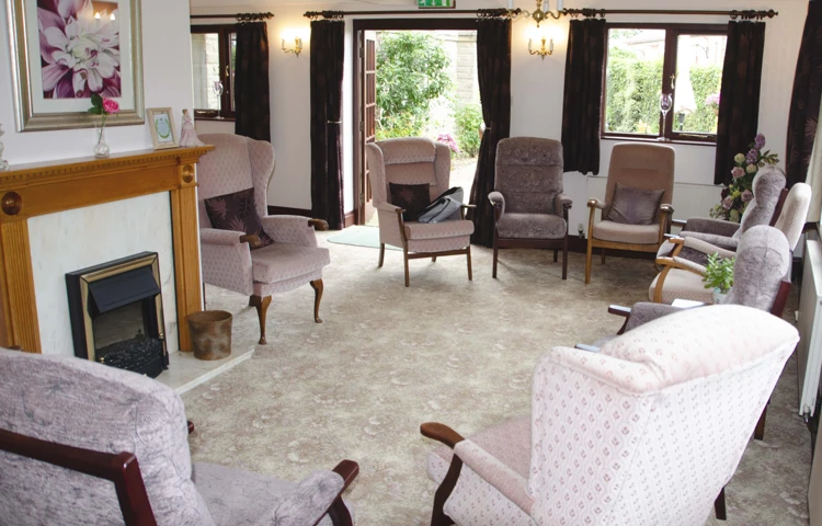 Lounge area with high-back chairs and fireplace at Castle View House, BB7 2DT
