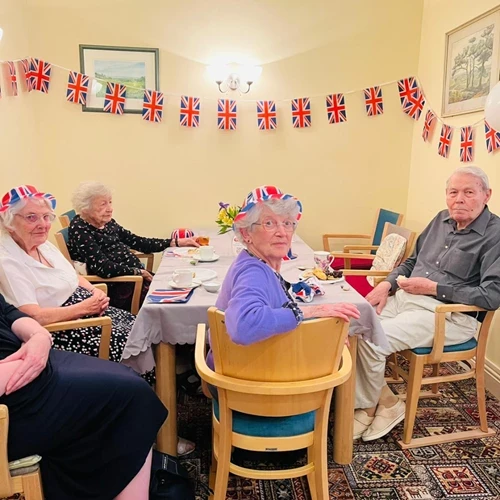 A group of older people at a table celebrating the queens jubilee