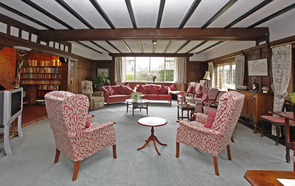 Large living room with beamed ceilings where residents can relax and socialise