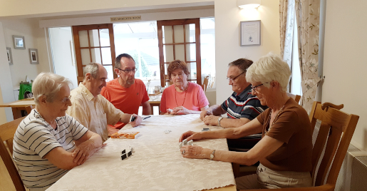Residents sit around a table playing games
