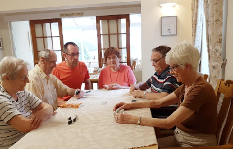 Residents sit around a table playing games