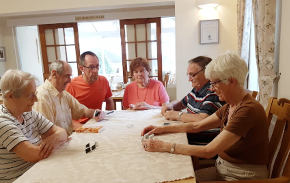 Residents sit around a table playing games