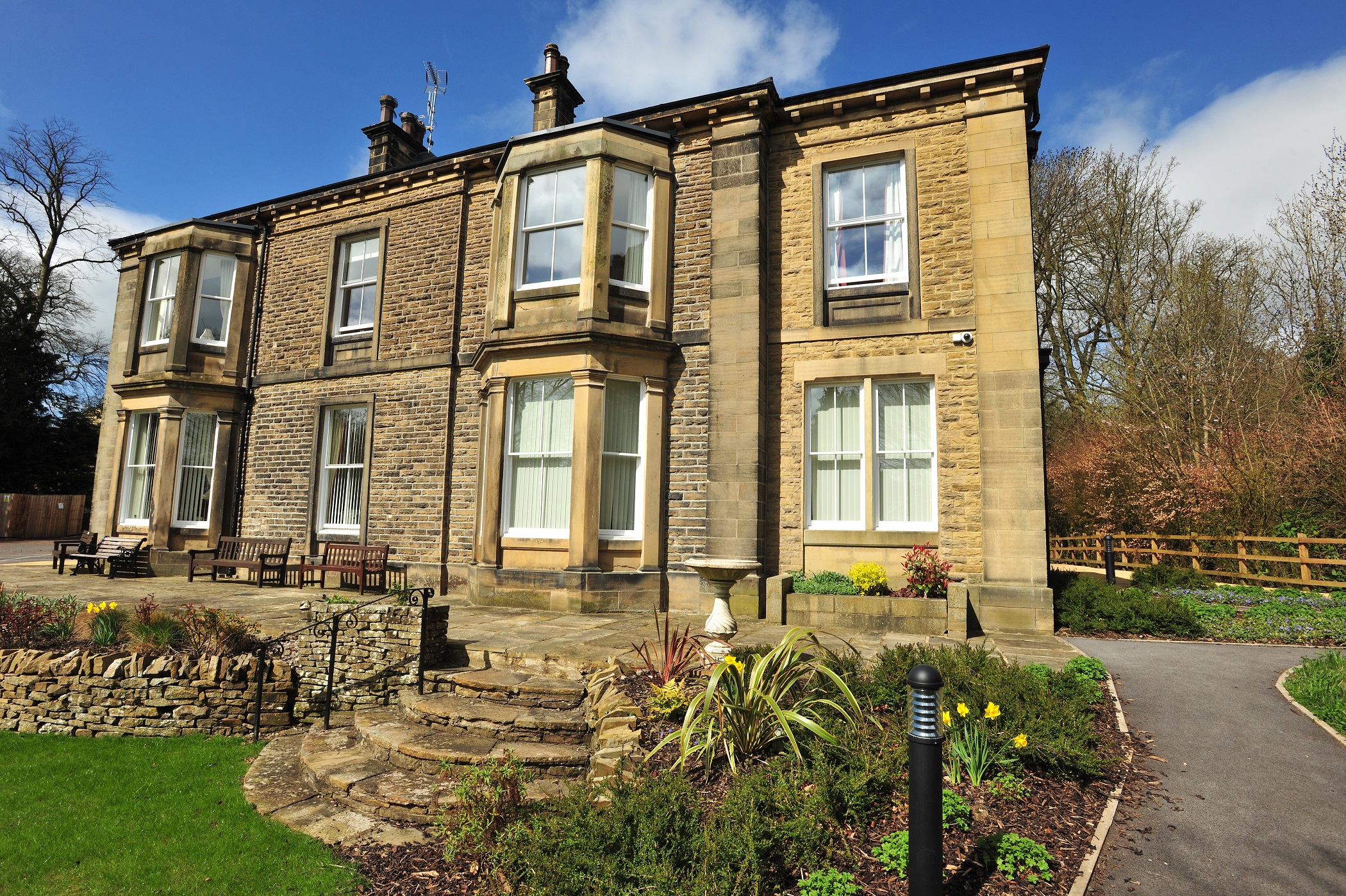 Full view of the house with stone steps into the garden