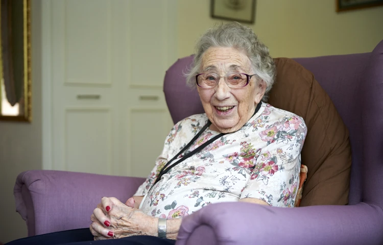 Residents smiling in her room at Westhall House, Horsted Keynes