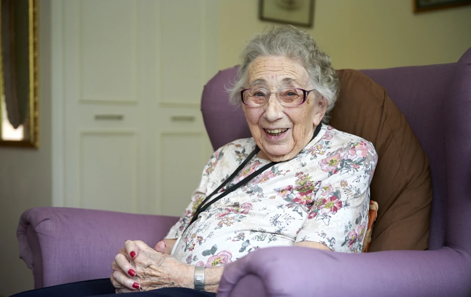 Residents smiling in her room at Westhall House, Horsted Keynes
