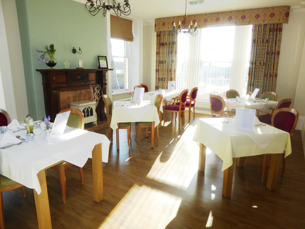 Residents dining area with tables set for dinner
