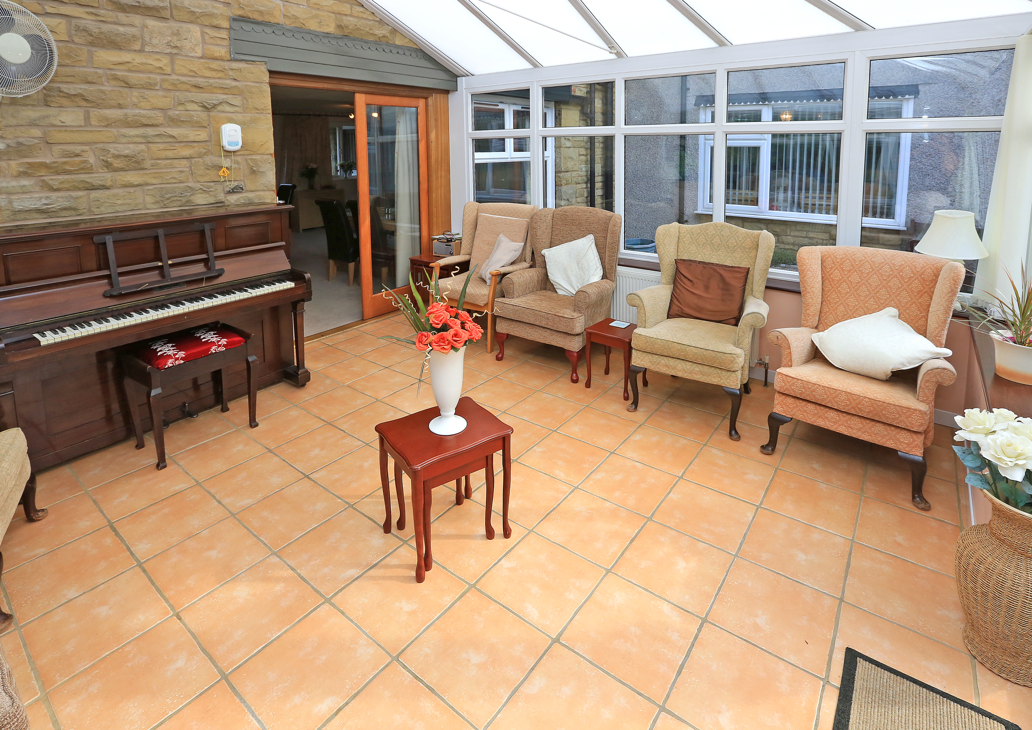 A conservatory with seating and a piano