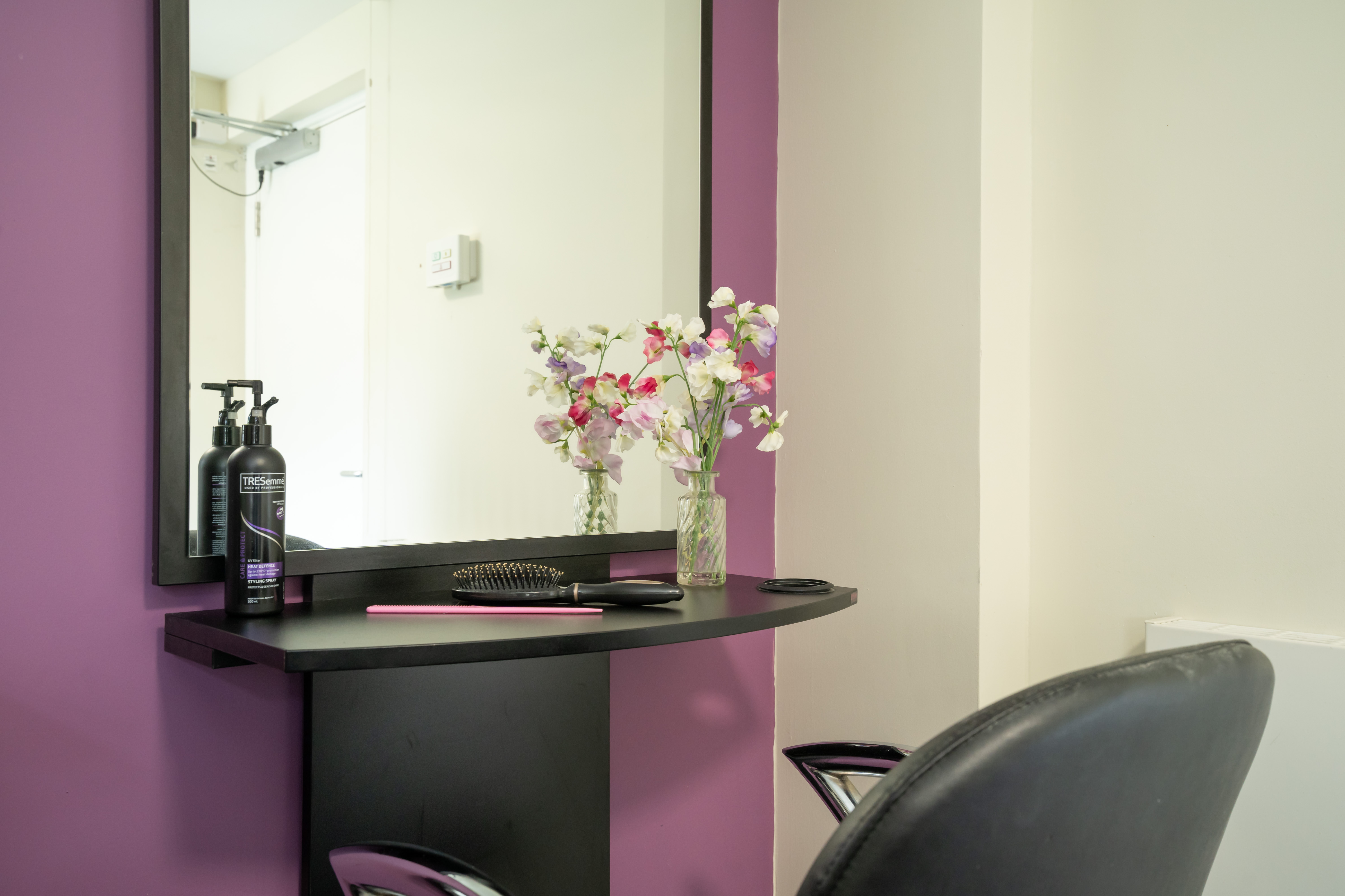 Pratt House hair salon with purple and grey decor